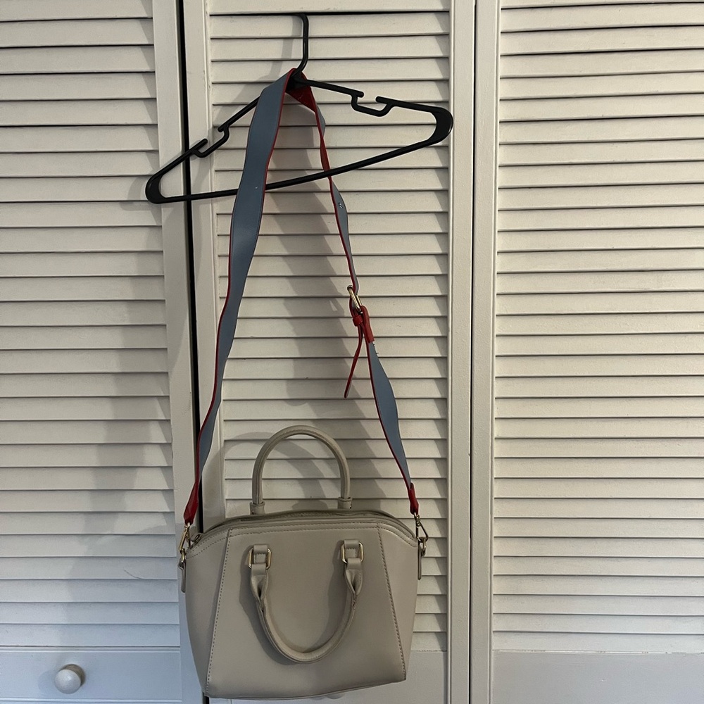Stylish Cream Handbag with Red and Blue Strap